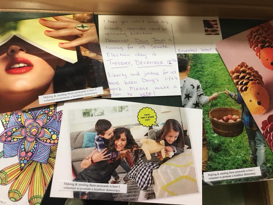 Several postcards, showing: a family playing a dog, two children holding a basket of apples, and a message to vote for Doug Jones for US Senate.