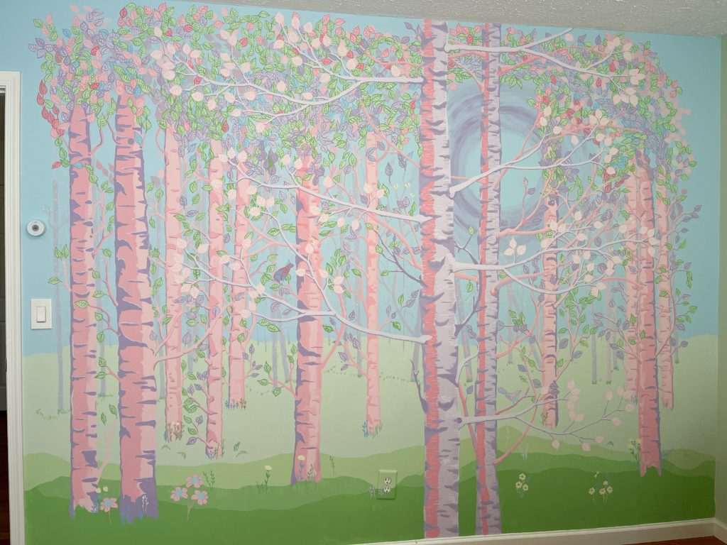 Fantasy forest mural of birch trees in pinks and purples.